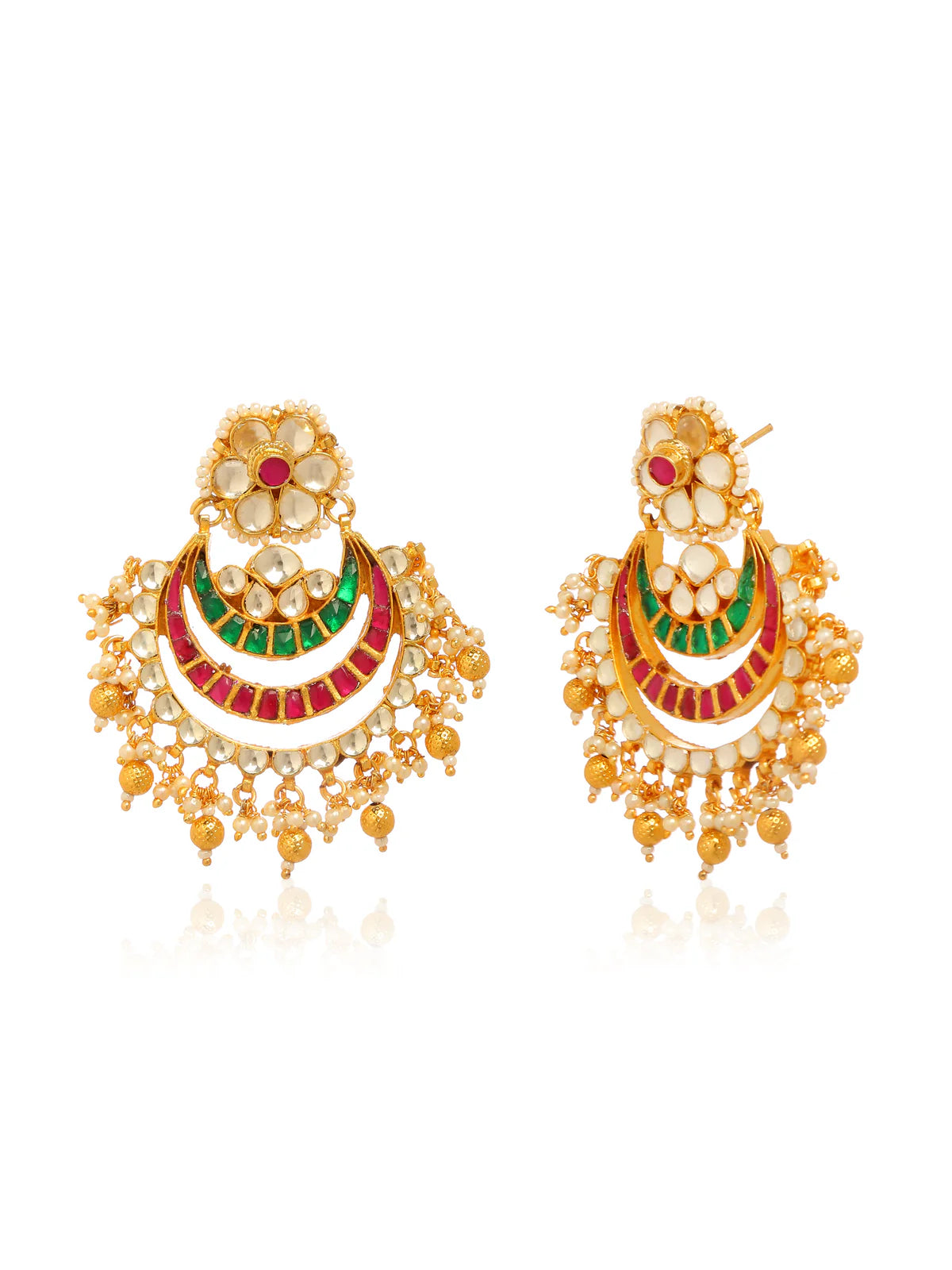 Gold earrings adorned with red green and white stones in an Indian style.