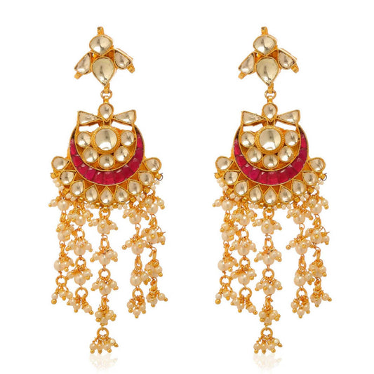 A pair of gold Indian dangler earrings with red and clear coloured gemstones and adorned with pearls.