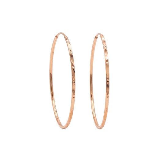 Rose gold hoop earrings on a white background