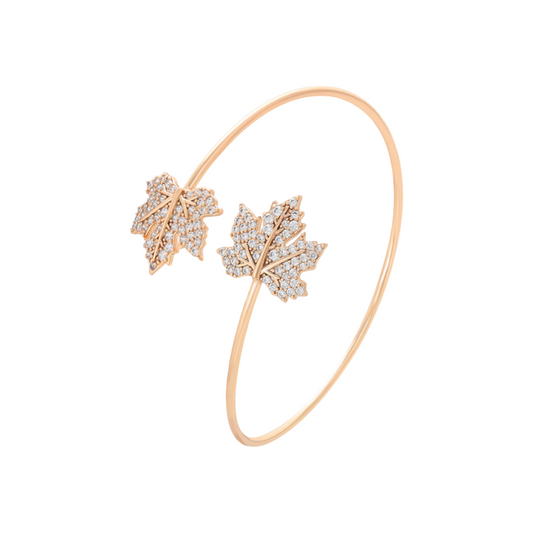 Rose gold bracelet with leaf designs on a white background