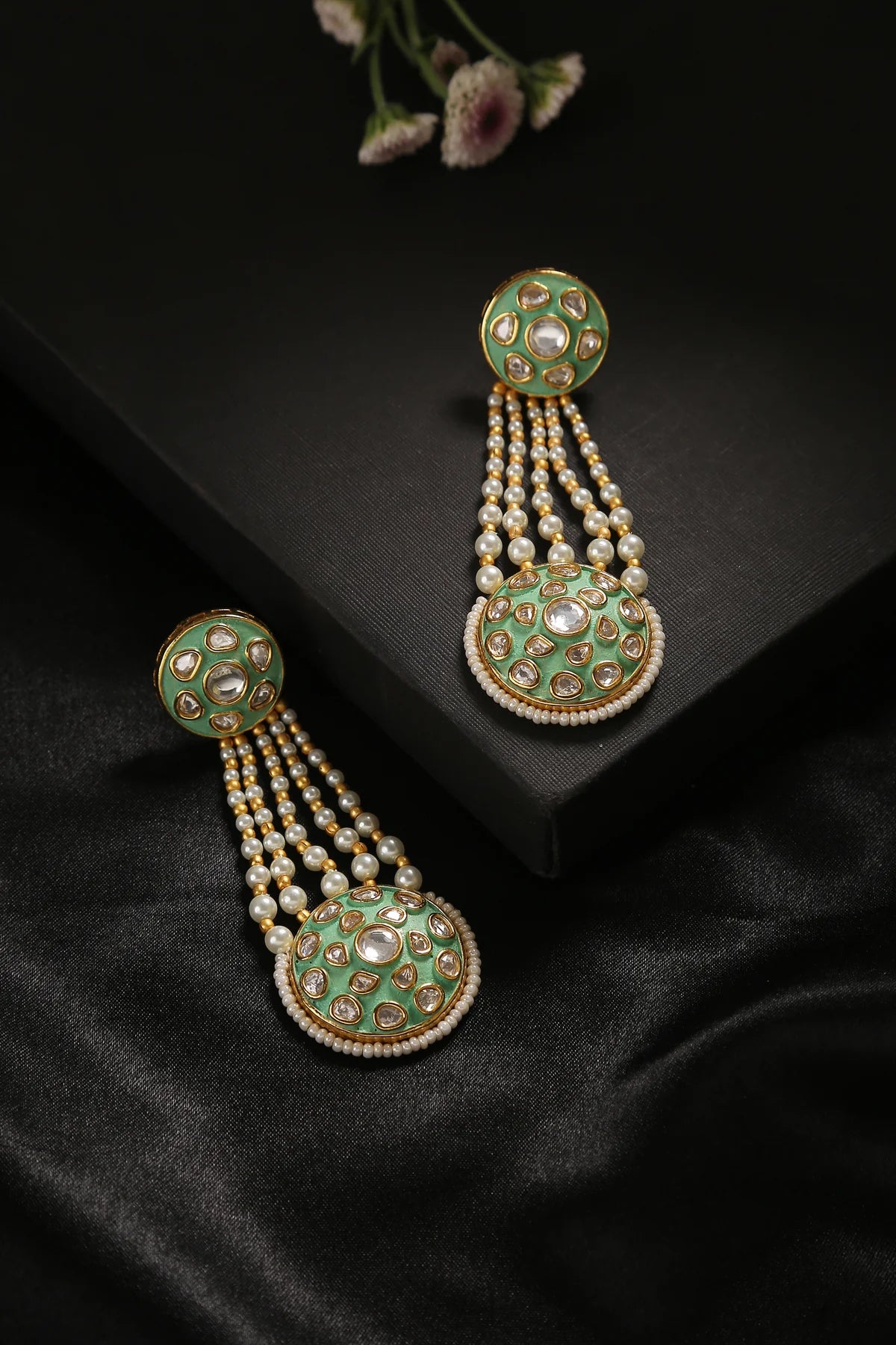 Pastel green gold plated Indian inspired design drop earrings.