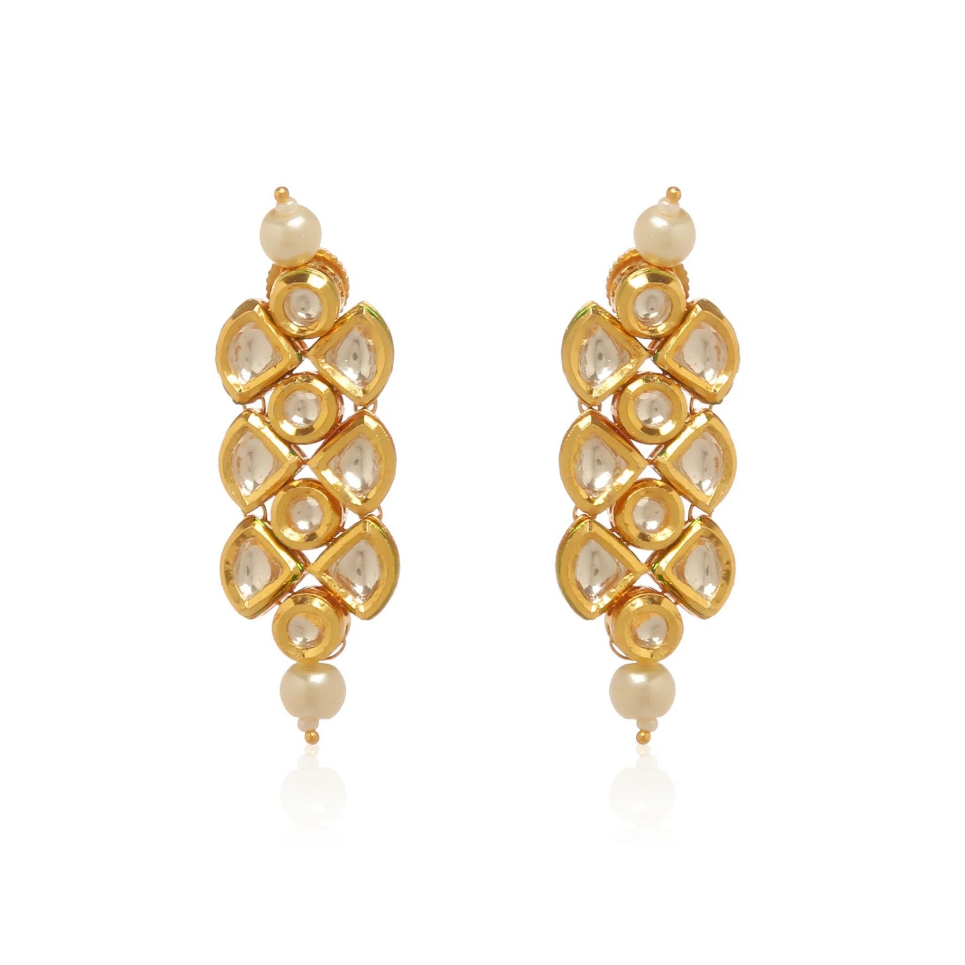 Gold earrings with pearls and clear stones on a white background