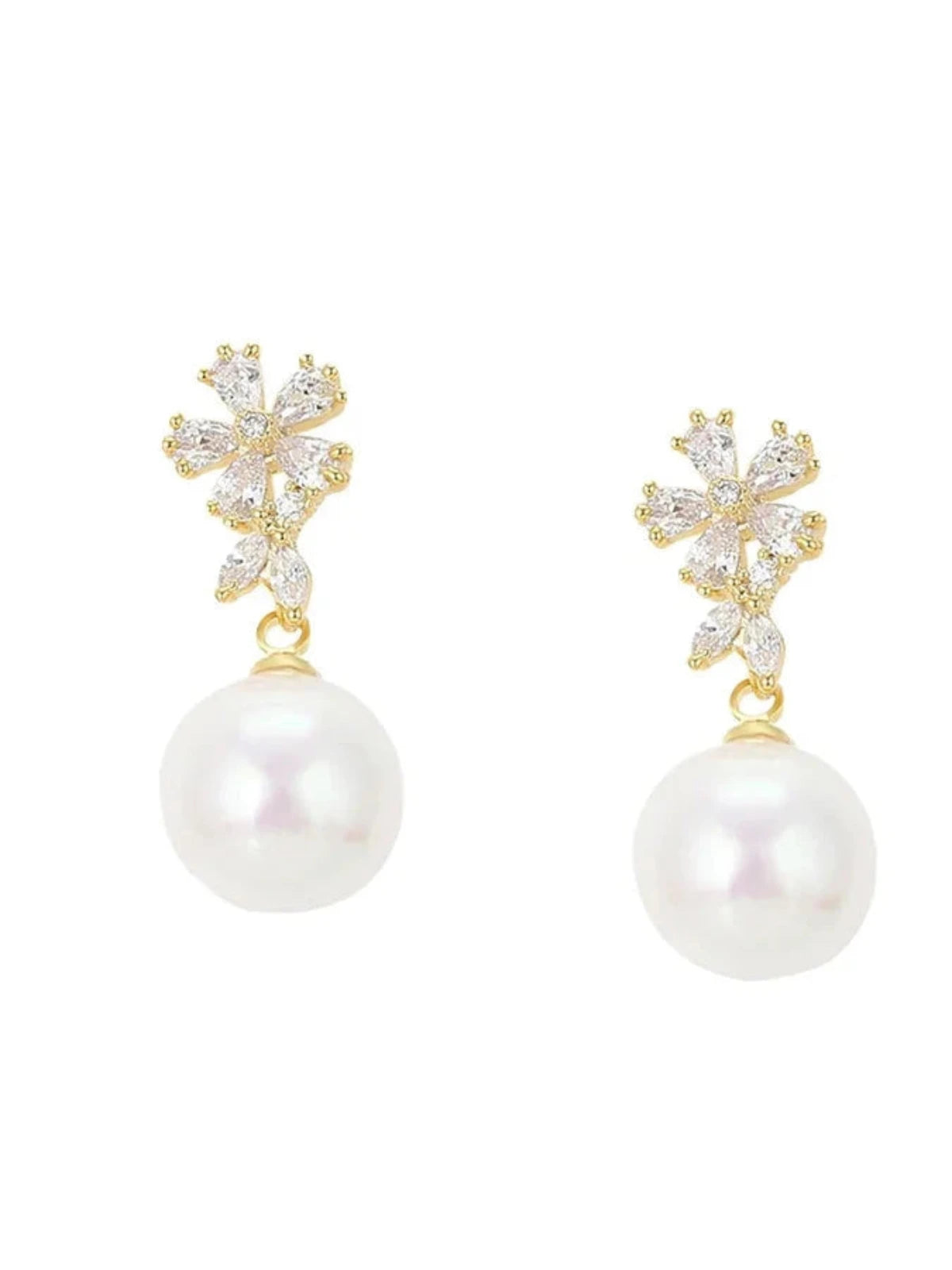 A pair of pearl drop earrings with gold plating and sparkling zirconia stones against a white background.