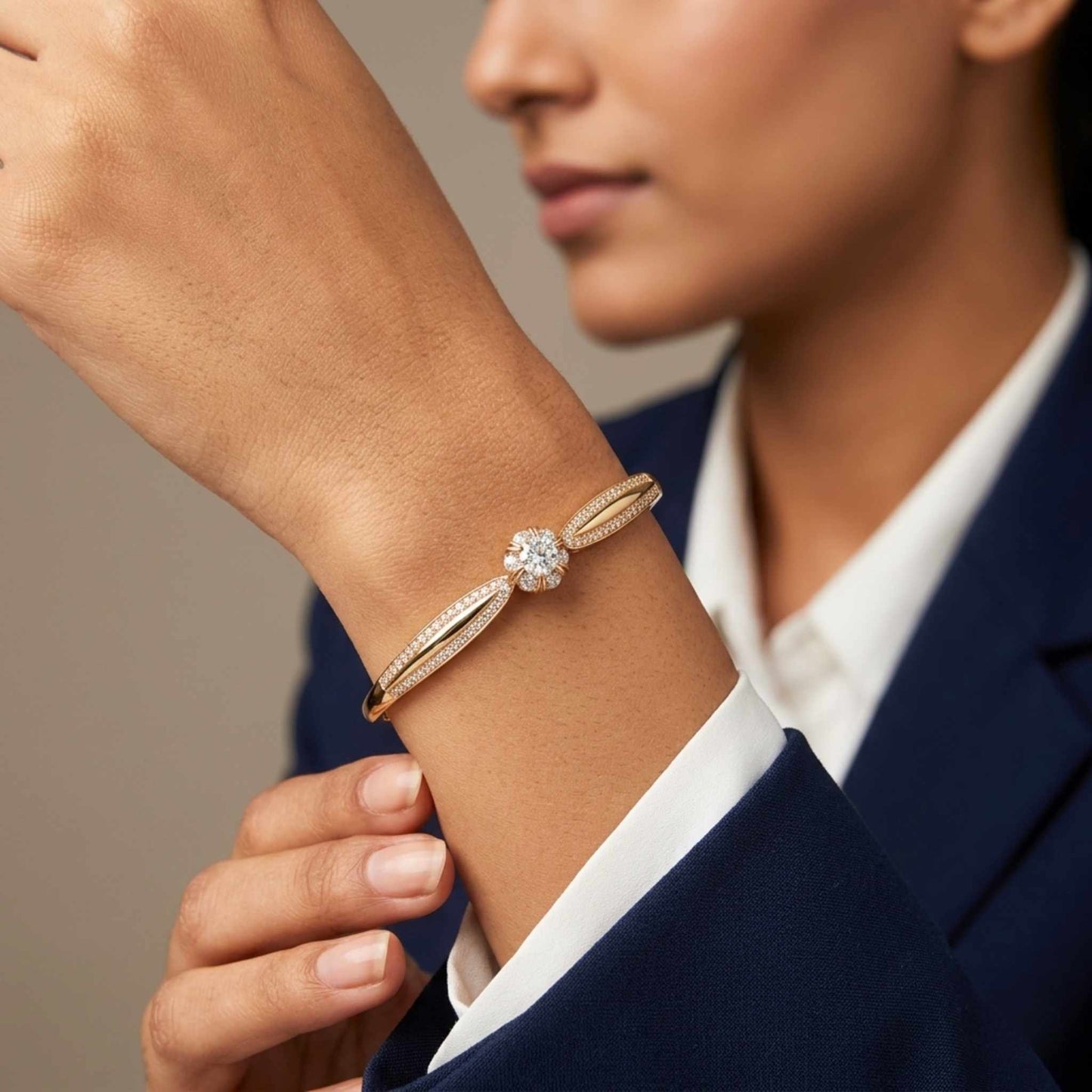 Close-up of a women wearing a gold diamond bracelet on a neutral background.  Digitally rendered model for scale