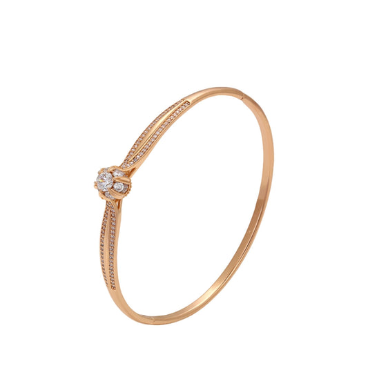 Rose gold bracelet with gemstone accents on a white background