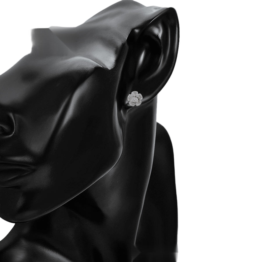 White gold floral earring on a model against a light background