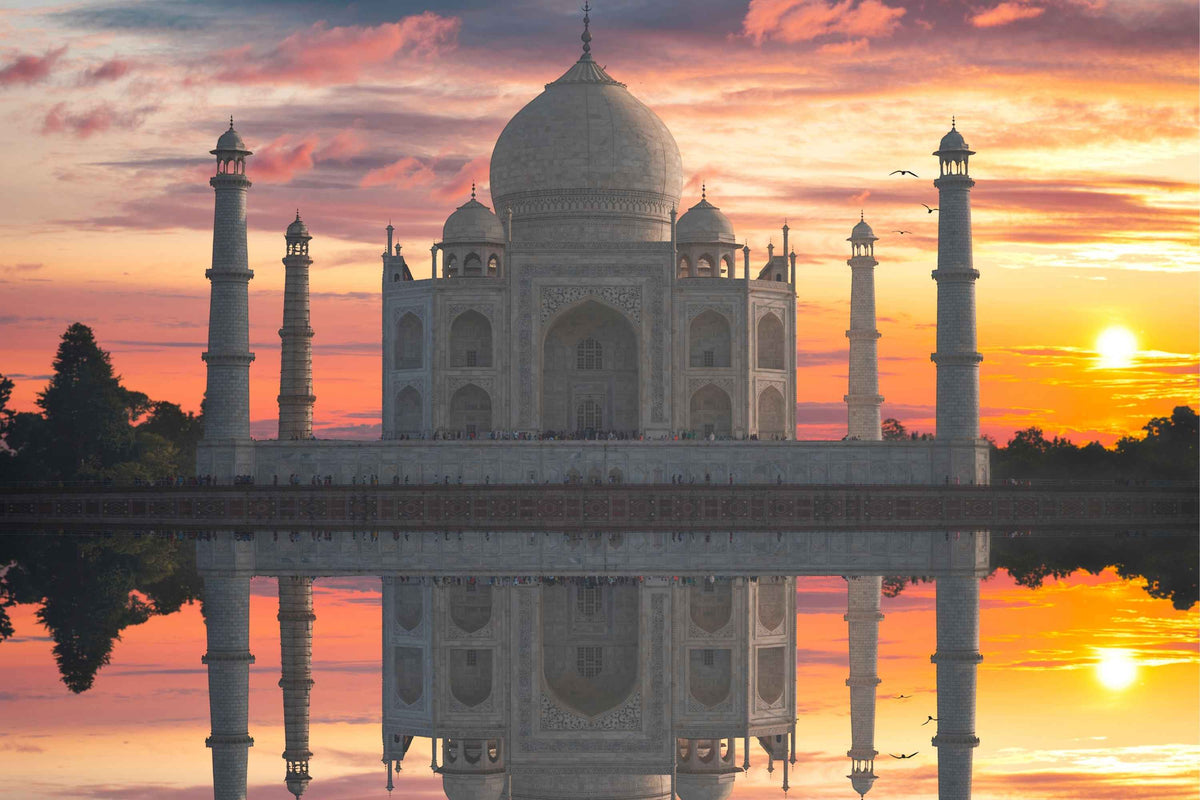 Taj Mahal at sunset with a warm orange and pink sky reflected in the water below promotion  for Elegance 4 Jewellery Ethnic style collection
