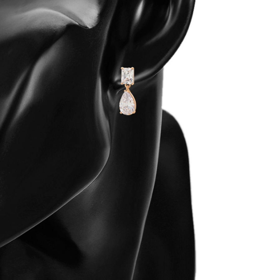Teardrop-shaped earring on a model against a white background.