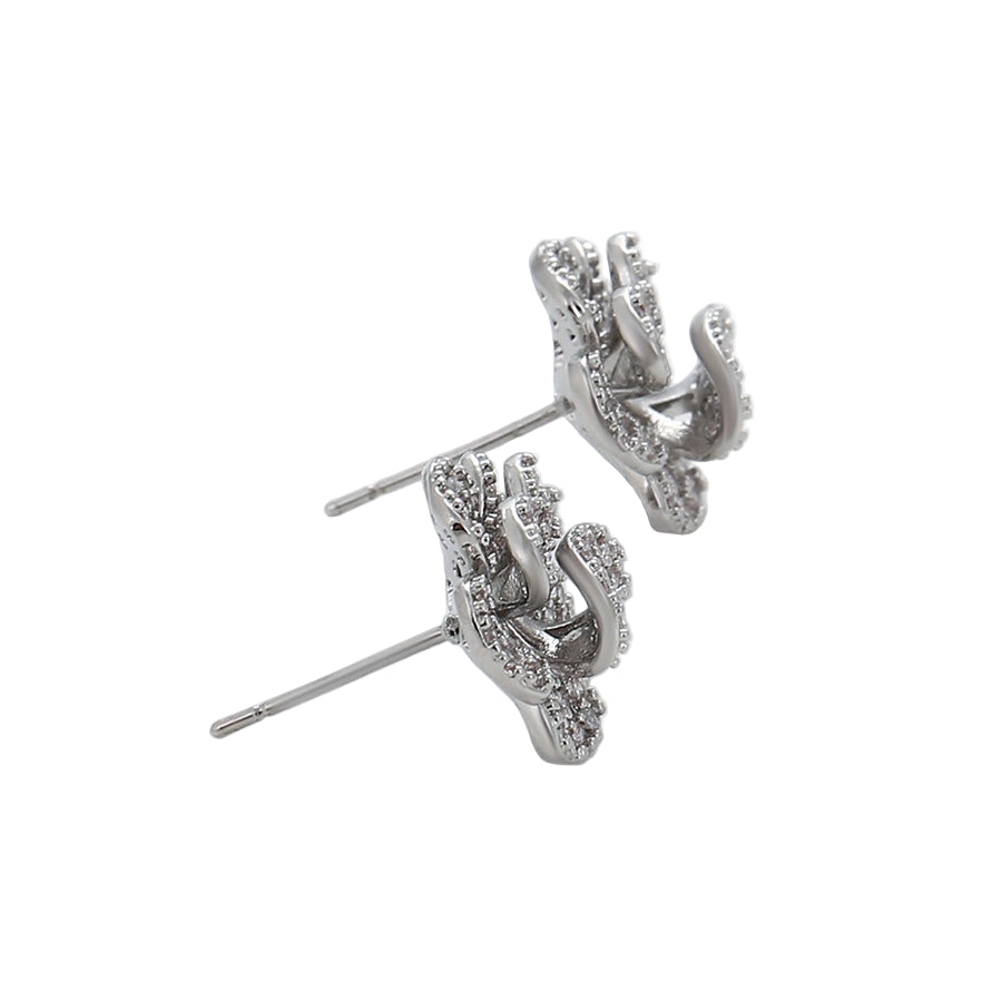 Pair of white gold stud earrings on a light background