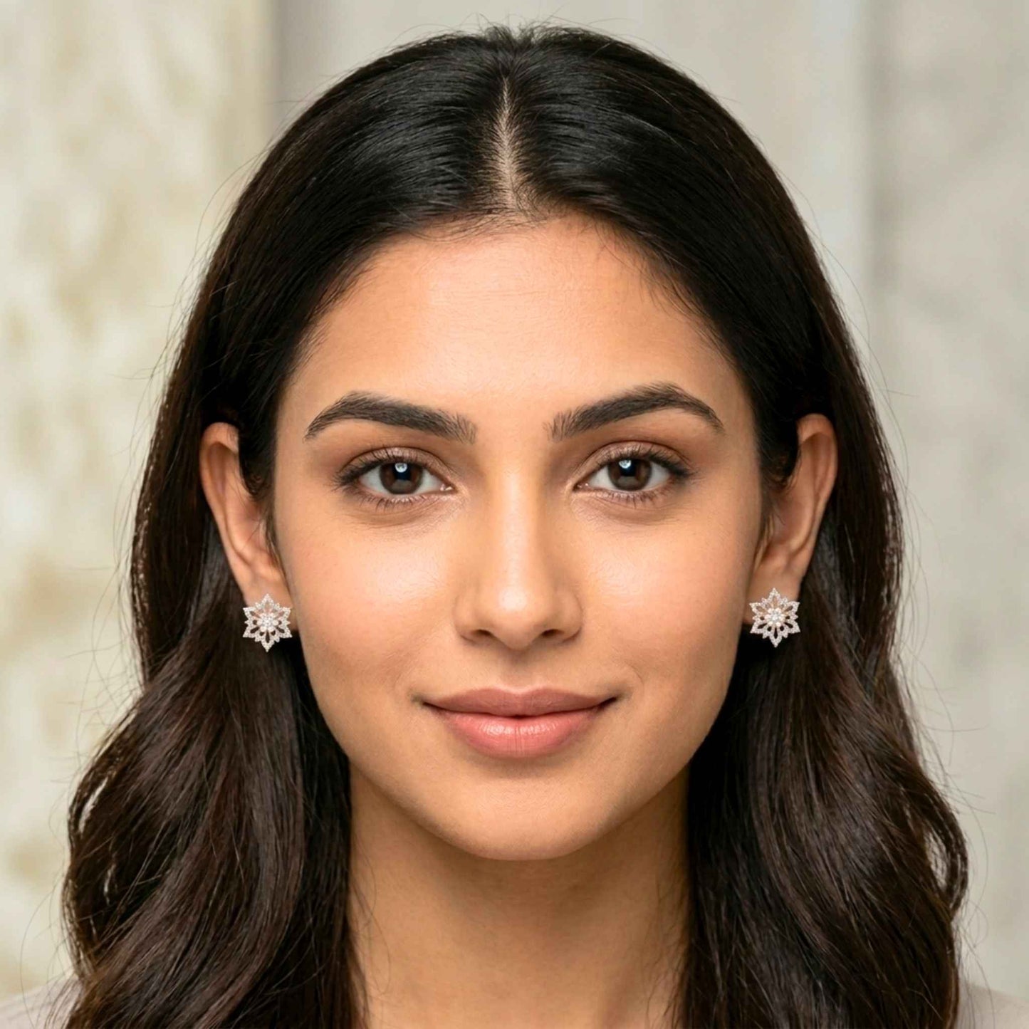 Close-up of a woman wearing earrings with a neutral background.  Digitally rendered model for scale.
