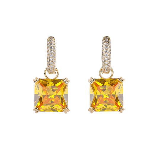 Pair of yellow square gemstone earrings on a white background