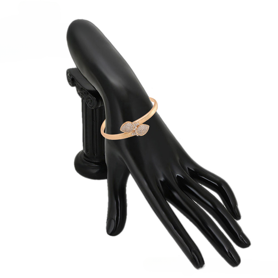 Gold bracelet  on a model's hand with a white background