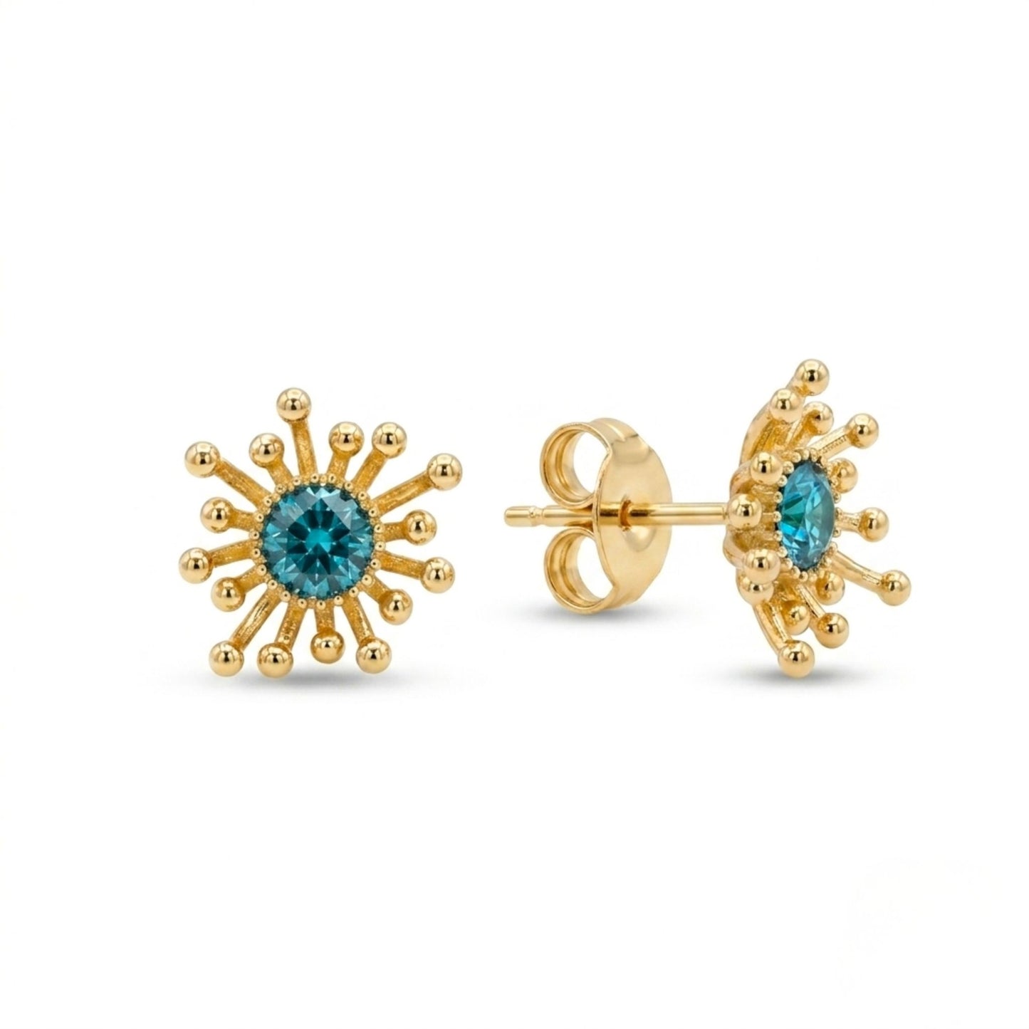 Gold earrings with blue gemstones on a white background