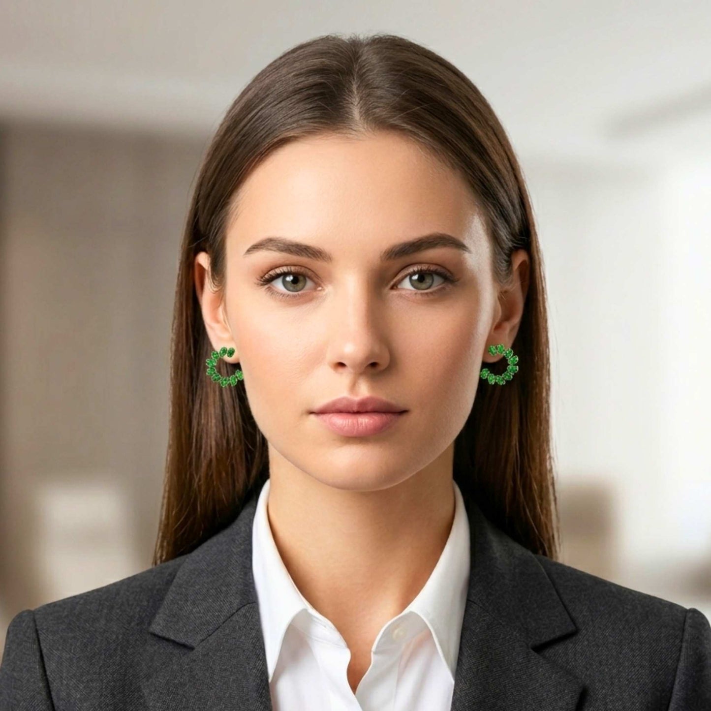 Woman wearing green earrings from Jewellery 4 Elegance collection set against a blurred background.  Digitally rendered model for scale