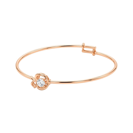 n 18k gold plated petite adjustable wire bangle bracelet featuring an openwork apple outline centrepiece set with a central brilliant round cubic zirconia stone, shown on a clean white background
