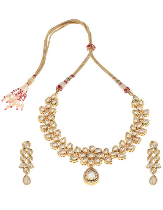 A gold-plated necklace with linked chain design and a matching set of earrings against a white background
