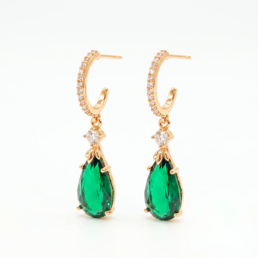 Warm gold-plated semi-hoop stud earrings embellished with clear pavé cubic zirconia and a hanging emerald green teardrop pendant from Jewellery 4 Elegance collection
