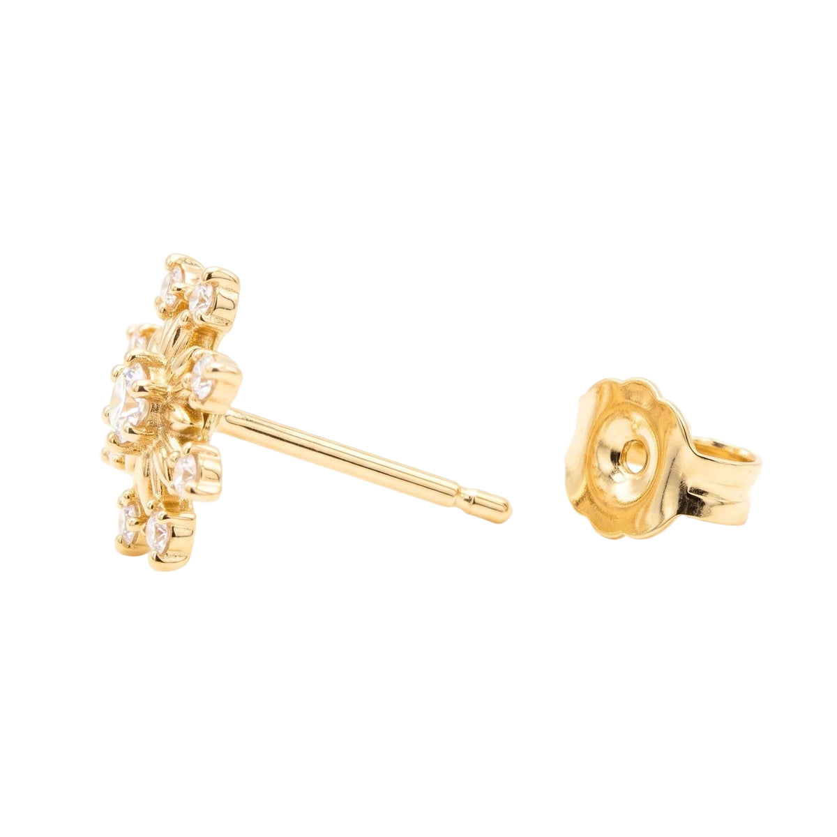 A pair of gold stud earrings on a white background, showing one earring from the front with a snowflake design of clear stones and the other earring from the side showing the stud back.