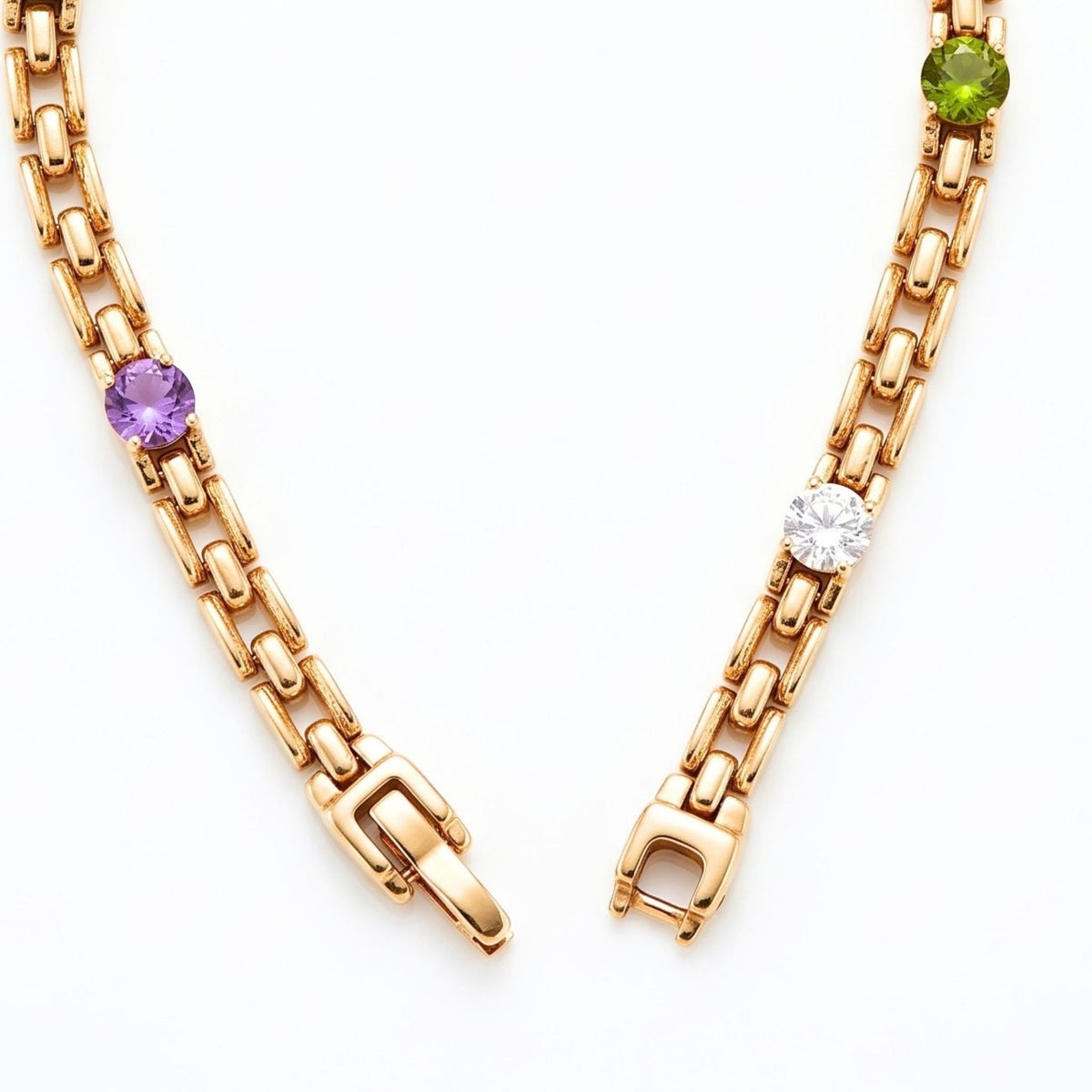 A gold link chain bracelet shown on a white background, featuring a round purple, green and clear gemstones from the Jewellery 4 Elegance collection.