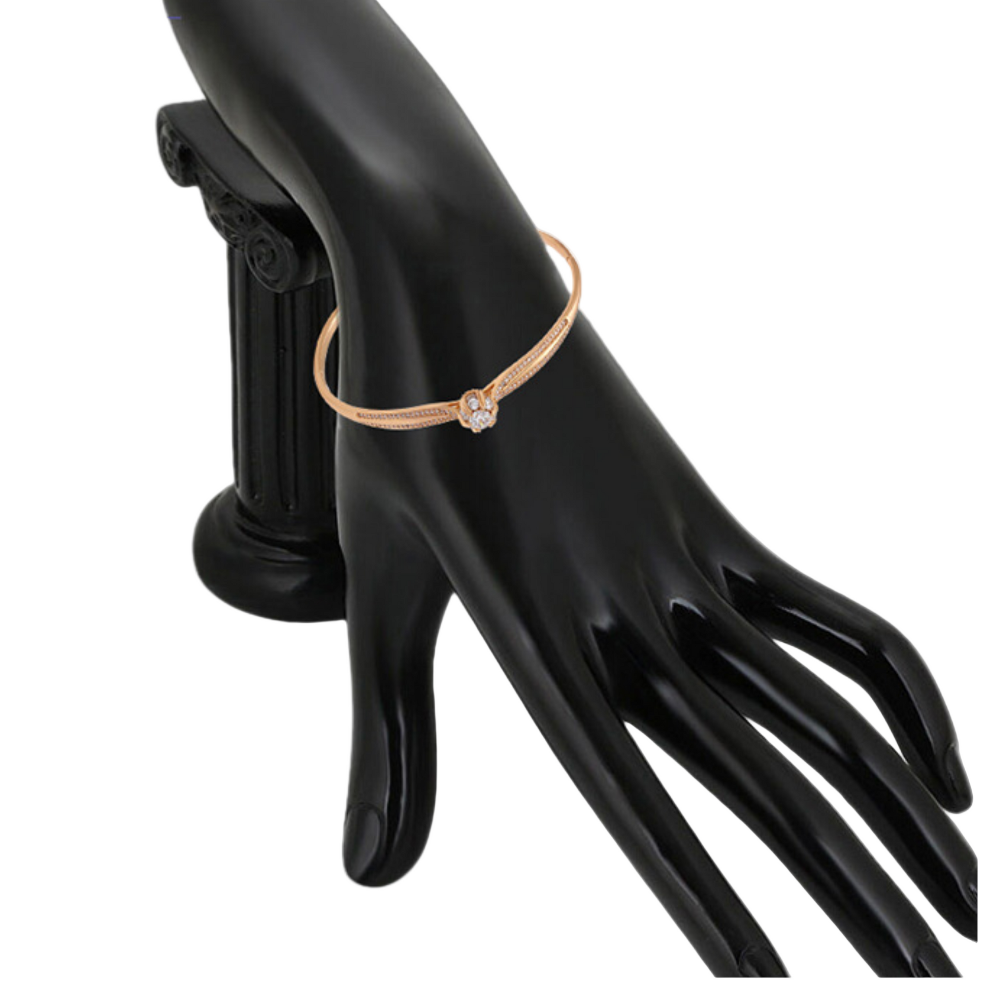 Gold bangle on a model hand against a white background 
