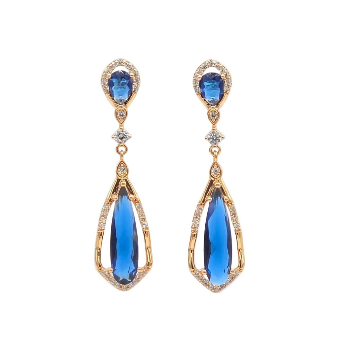 A pair of gold drop earrings featuring oval blue gemstones at the top and larger teardrop-shaped blue gemstones hanging below, accented with small clear stones, shown on a plain white background from the Jewellery 4 Elegance collection.
