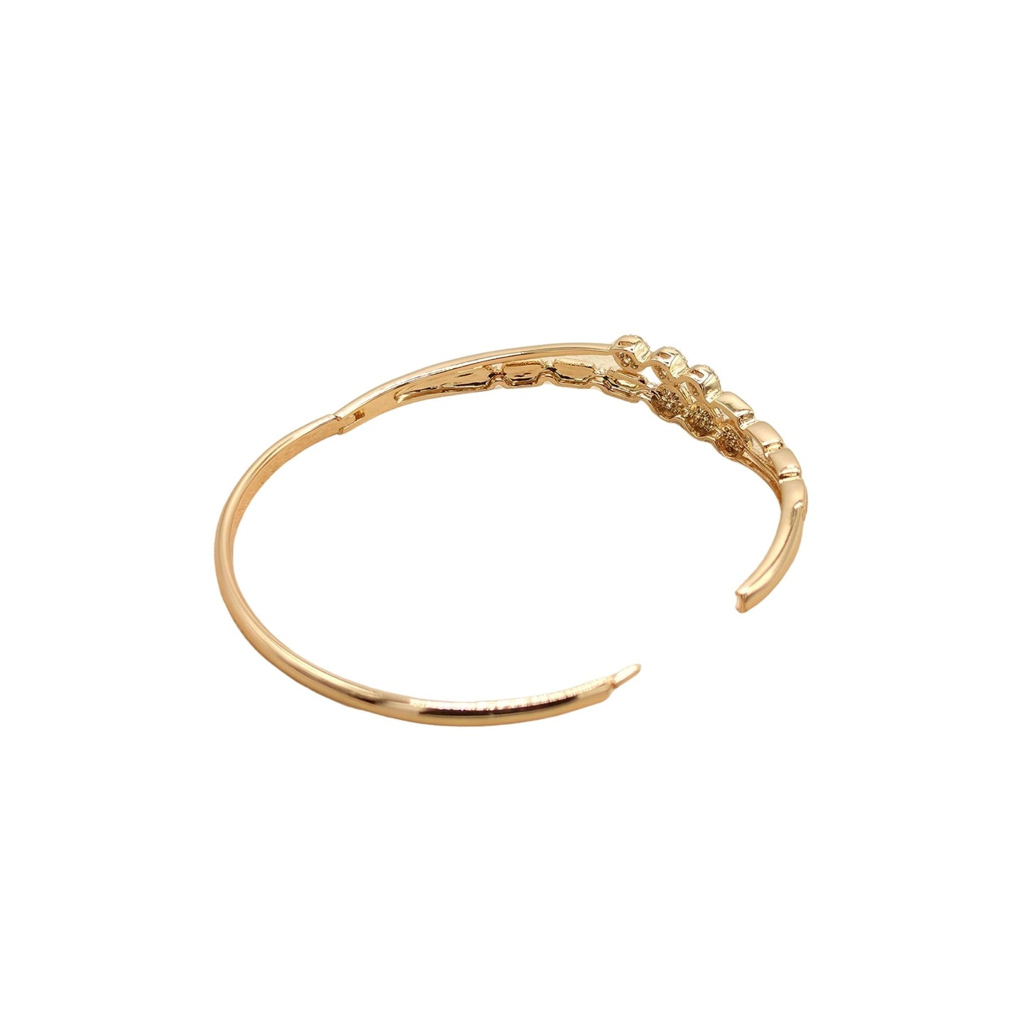Gold bracelet with a concealed integrated snap closure on a white background
