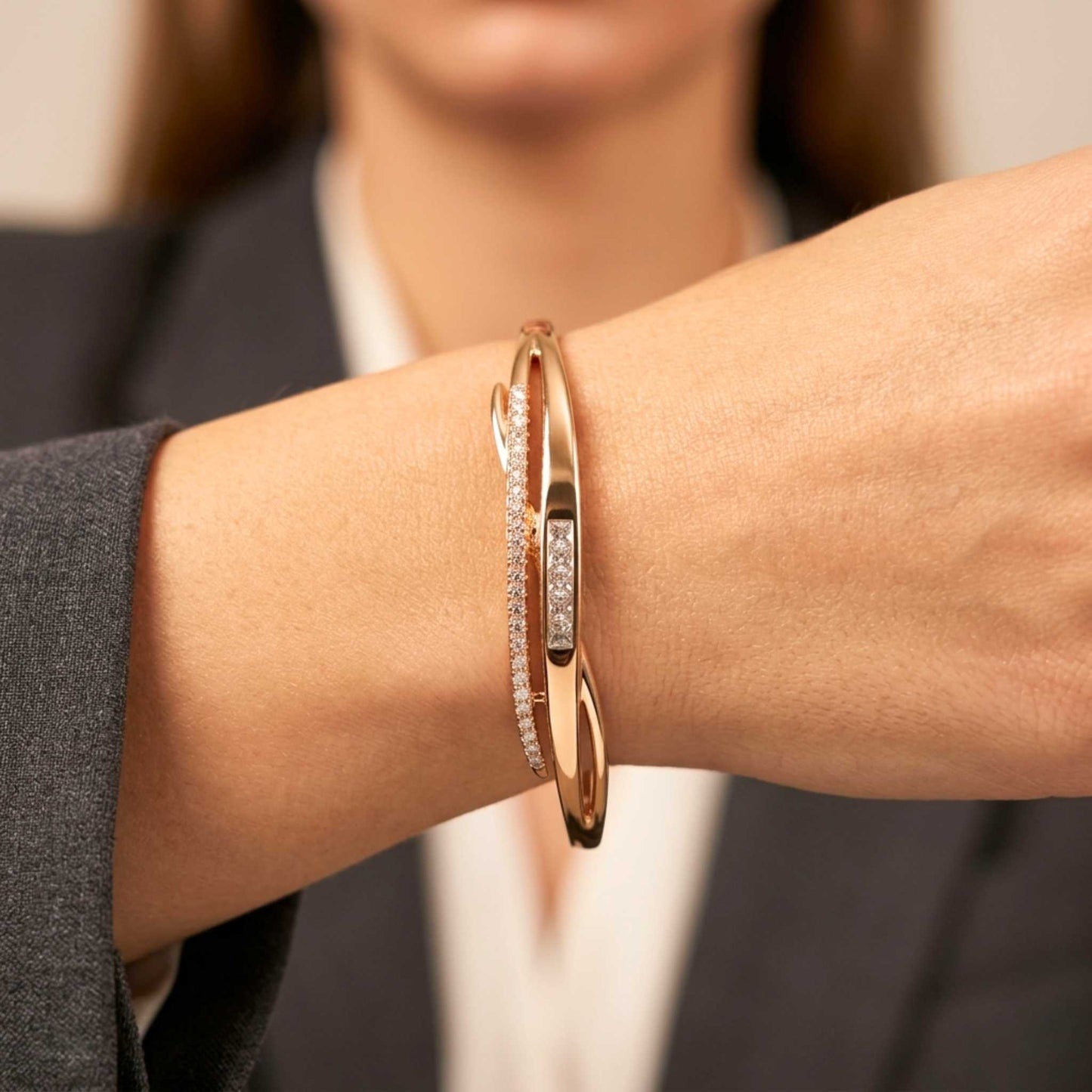 Close-up of a wrist wearing a gold bangle bracelet from the Jewellery 4 Elegance collection set against a blurred background.  Digitally rendered model for scale