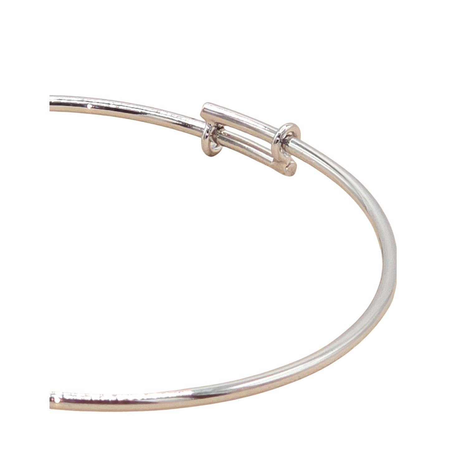Close up of the a white gold bangle from the Jewellery 4 Elegance collection, set against a white background.  
